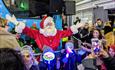 Santa with children in front of the bus at the Barbican Christmas Lights switch on in Plymouth