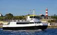 Plymouth Venturer at sea with Plymouth Hoe backdrop