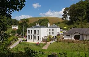 white manor house and gardens
