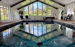 swimming pool with view of fields