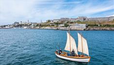 Boat sailing across Plymouth Sound