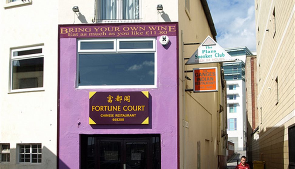 The purple painted outside of Fortune Court showing the entrance and adjacent alleyways.