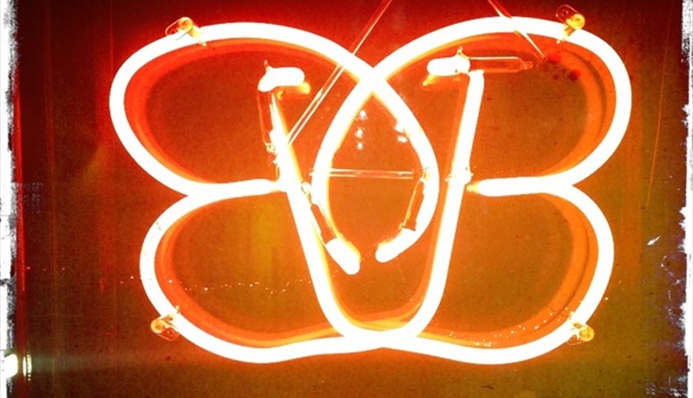 Brightly lit neon sign of the B-bar