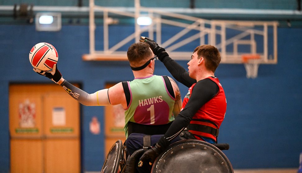 Two wheelchair rugby players battle to win the ball