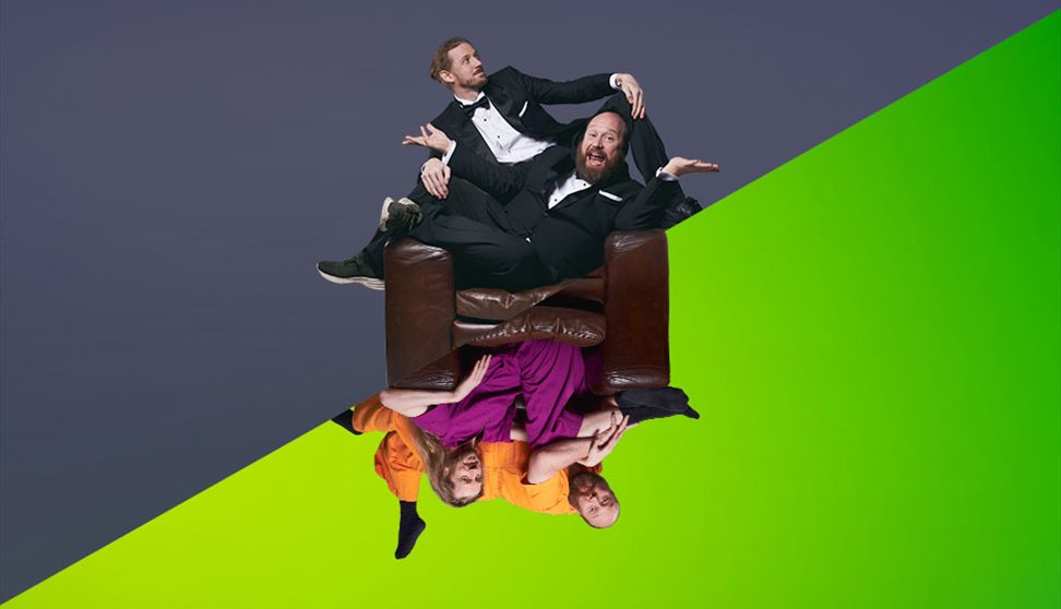 The image is split diagonally, one side is green and shows two men in bright pink and orange clothes. The other half is grey and they wear tuxes with
