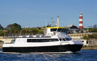 Plymouth Venturer at sea with Plymouth Hoe backdrop