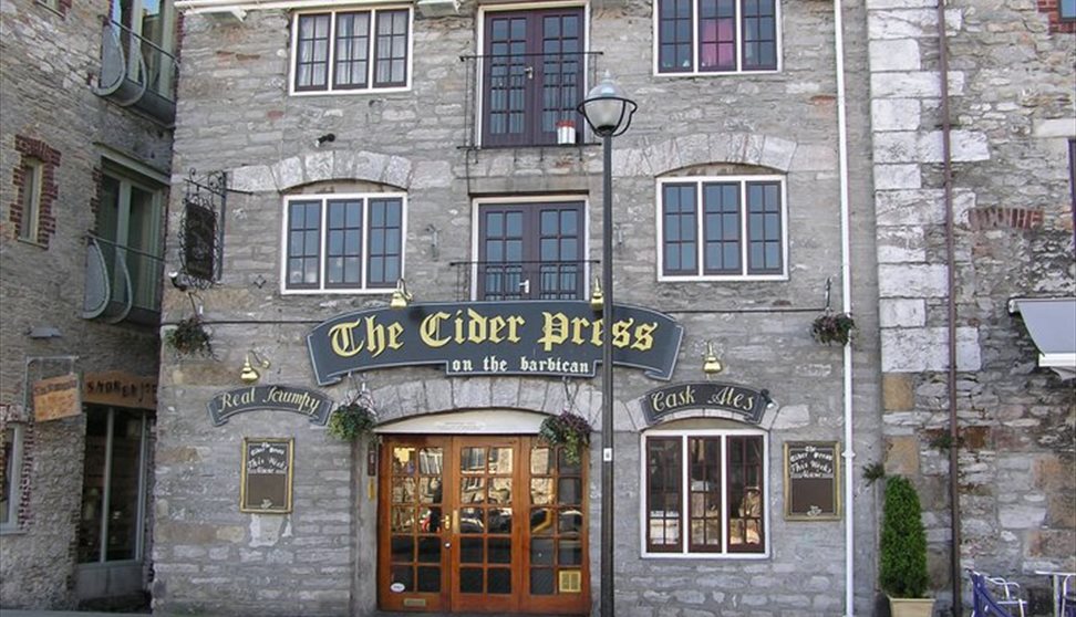 The stone outside of The Cider Press with wooden doors at the entrance.