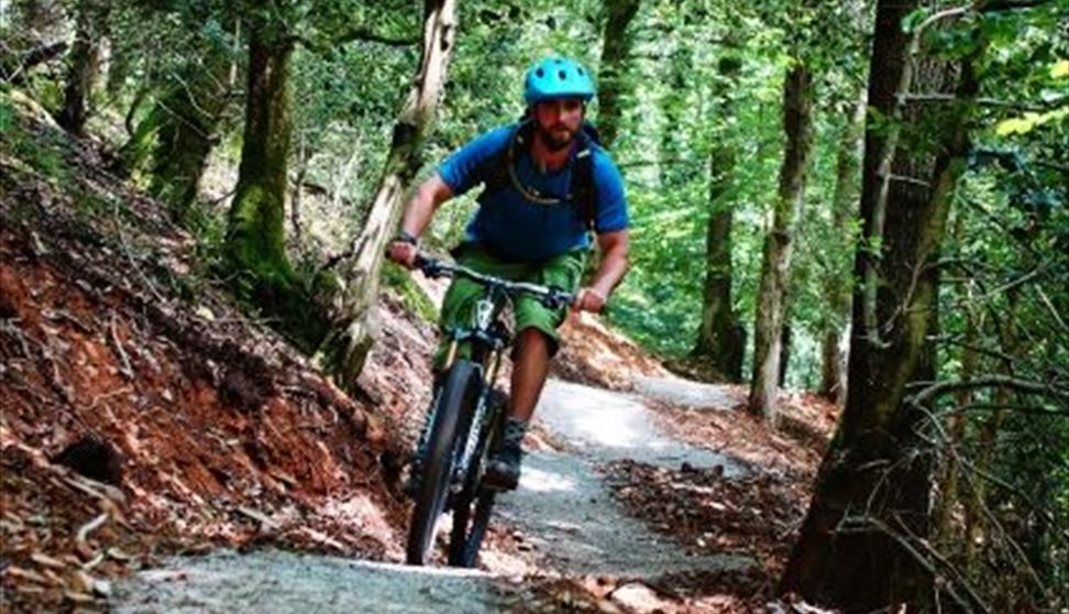 Cyclist riding through Drakes Trail.