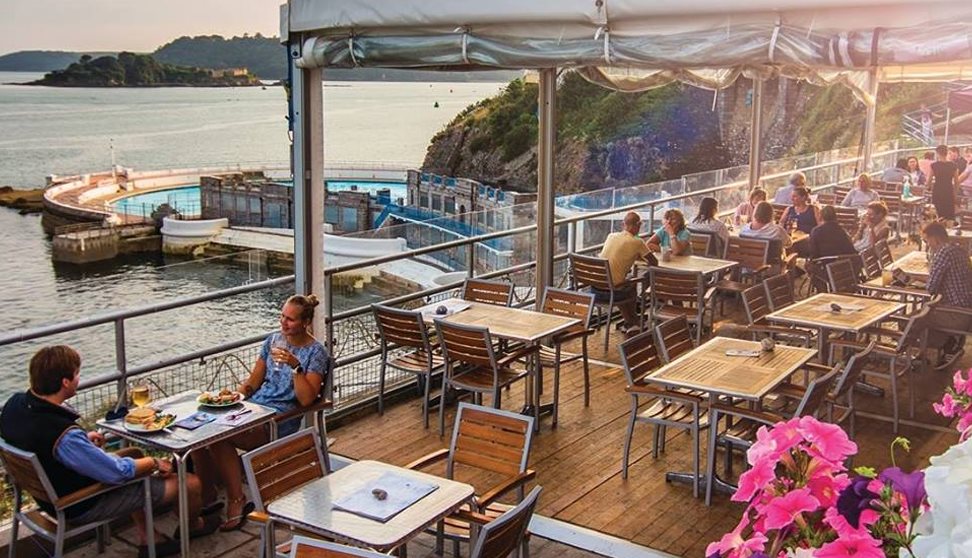 The Terrace's under cover outside seating area with customers eating and drinking. Beautiful views of Drake's Island and Tinside Lido.