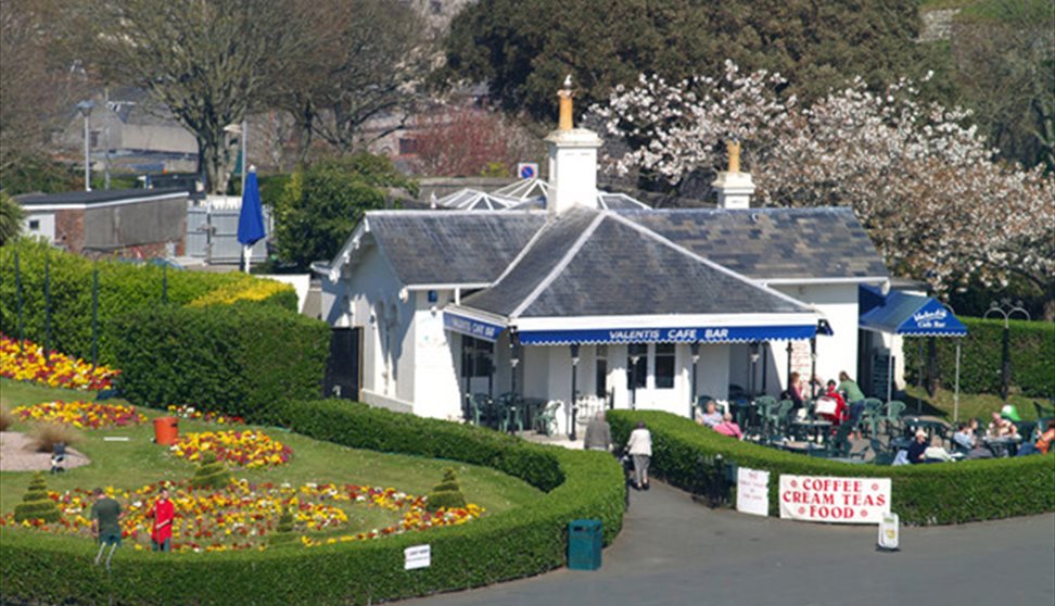 Valenti's and adjacent gardens shown from Plymouth Hoe with people sat outside