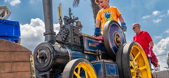 Boy on a small steam engine
