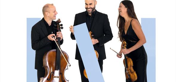 Three musicians are stood amongst blue graphic rectangles, holding their instruments and  laughing.