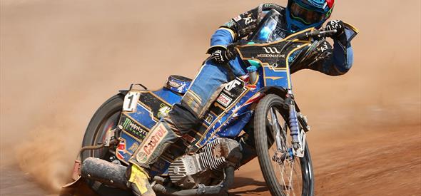 One of the Poole pirates skidding round the corner on the dirt track during a race