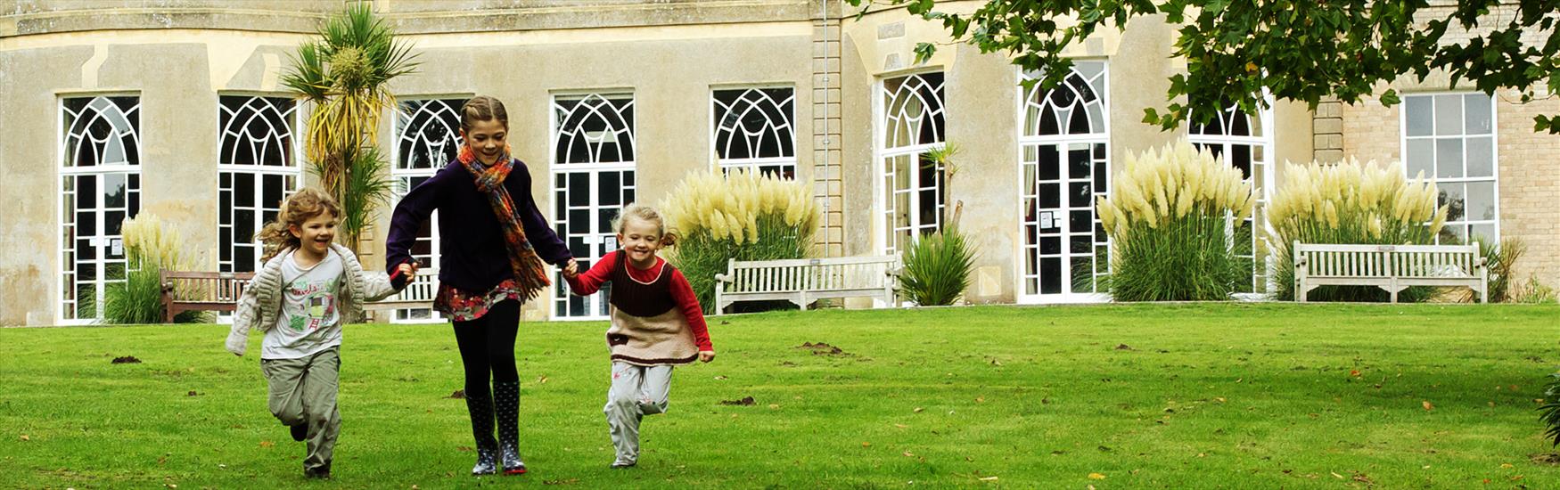 Kids running around in the Upton Country park grounds in Poole