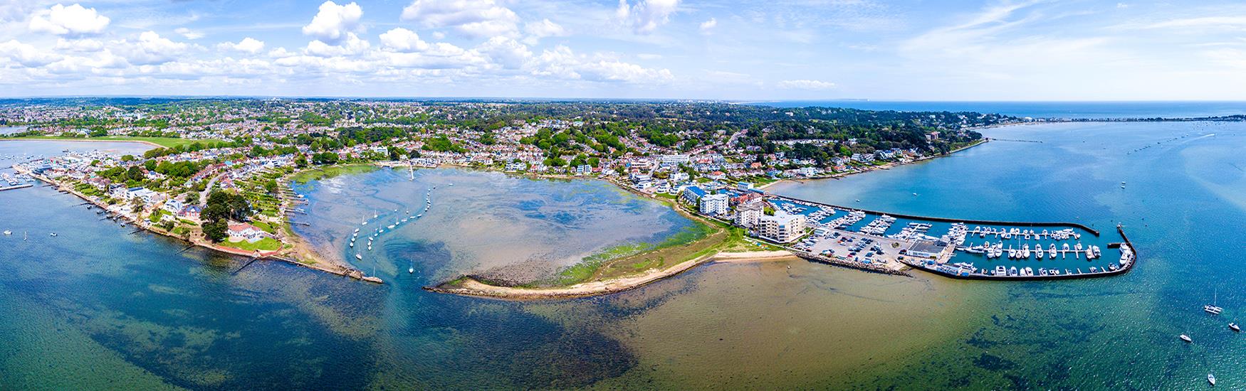 Aerial view of Poole harbour and marina with the blue hue of the sea enhancing the image