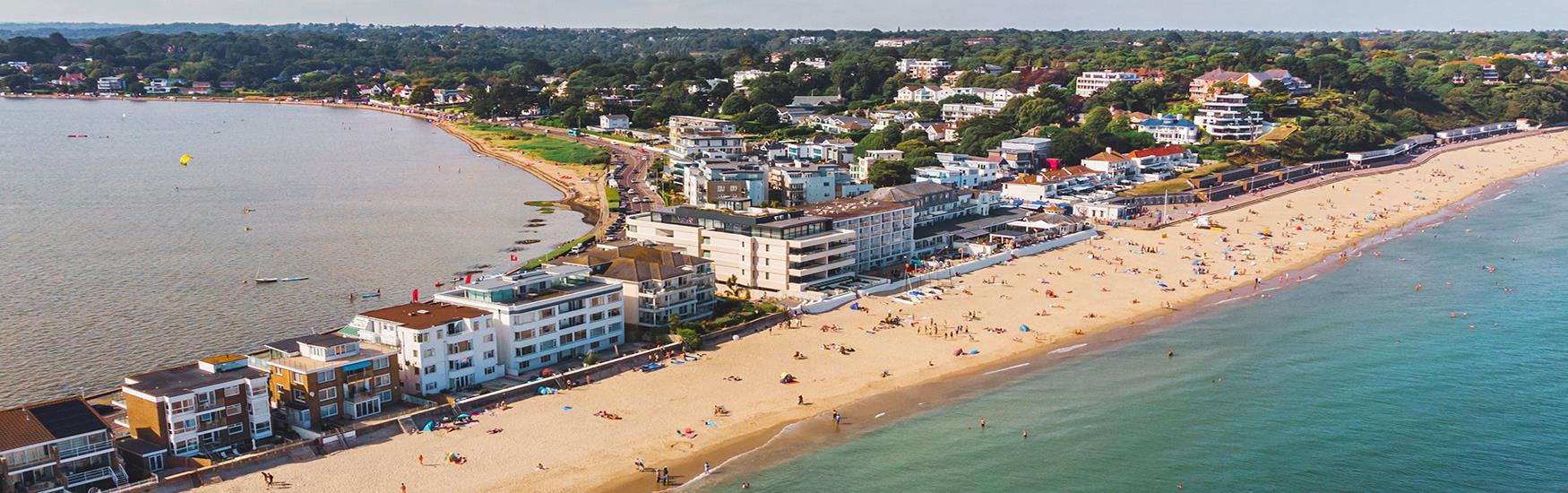Amazing birds eye shot of an area of Sandbanks beach with visitors lapping up the sun and sea on a lovely sunny day