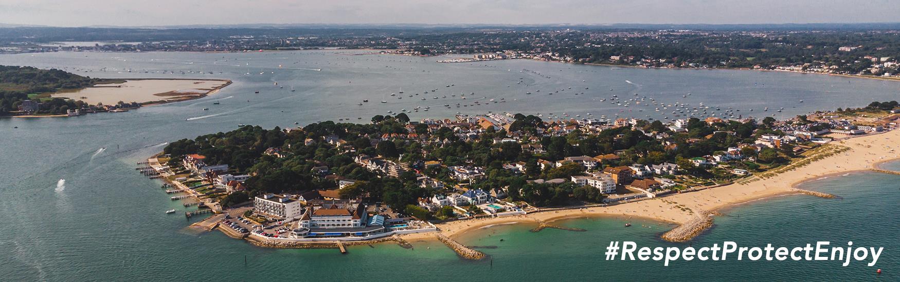 A shot of Poole Bay and Brownsea Island with Respect Protect and Enjoy messaging overlaying it