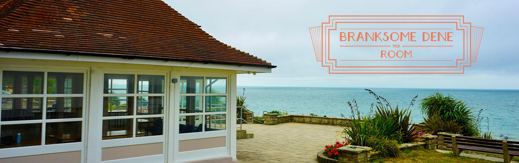 Stunning shot of Branksome dene room with beach in the background and the logo placed on top of the image