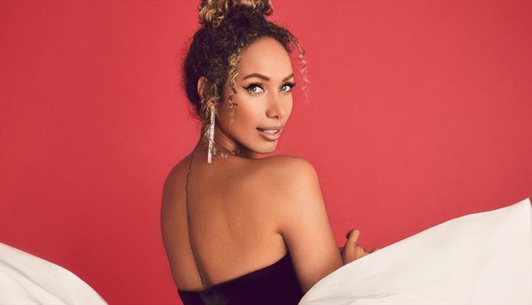 Leona Lewis  looking over her shoulder with a red background