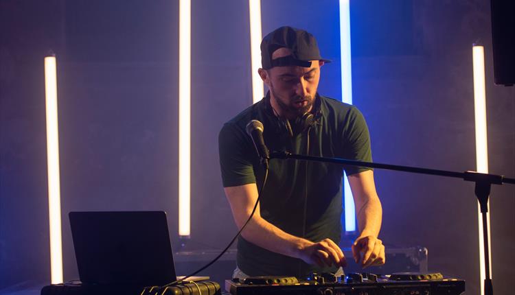 man djing in dark room