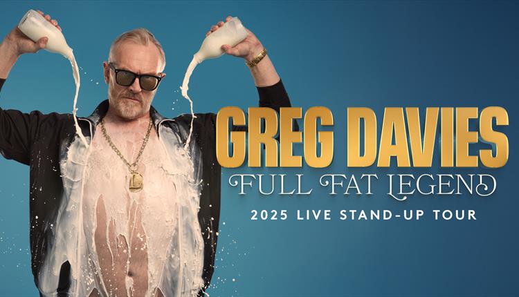 Greg Davies pouring out two milk bottles in an open black shirt showing his chest wearing sunglasses