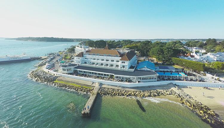 Drone shot over the sea of the Haven hotel and its jetty