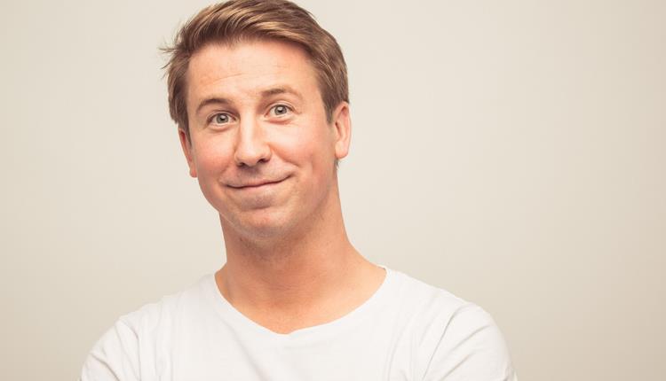 Man in white shirt smiling