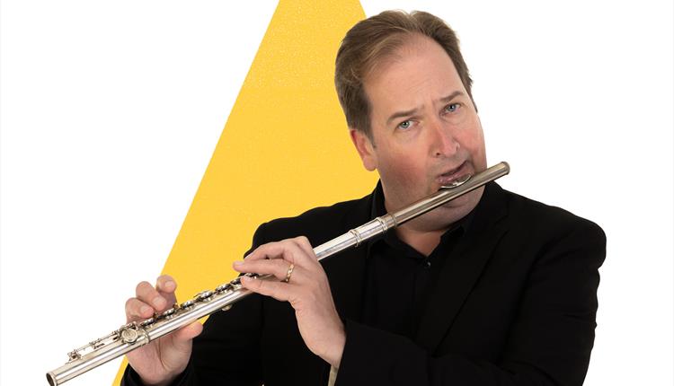 A BSO floutist is playing the flute in front of a yellow triangle graphic.