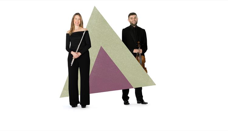 Two musicias are stood in front of a graphic of a triangle, whilst holding their instruments.