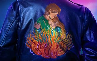 A leather jacket is embroidered with an image of a man and a woman holding each other, above flames.
