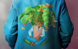A blue blazer is embroidered with an image of a man sitting underneath a tree. Birds fly above him.
