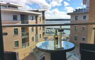 Balcony with table and chairs overlooking Poole Quay