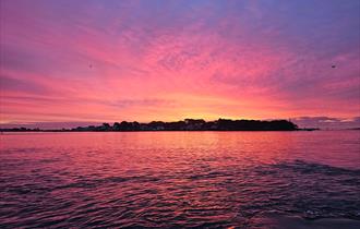 Pink sunset over Brownsea Island