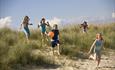 Five children running onto the beach at Knoll Beach in Studland, Dorset