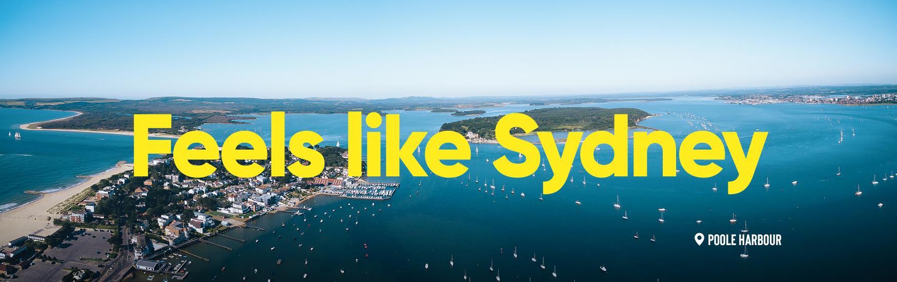 Aerial view of Sandbanks and the surrounding area with feels like sydney text