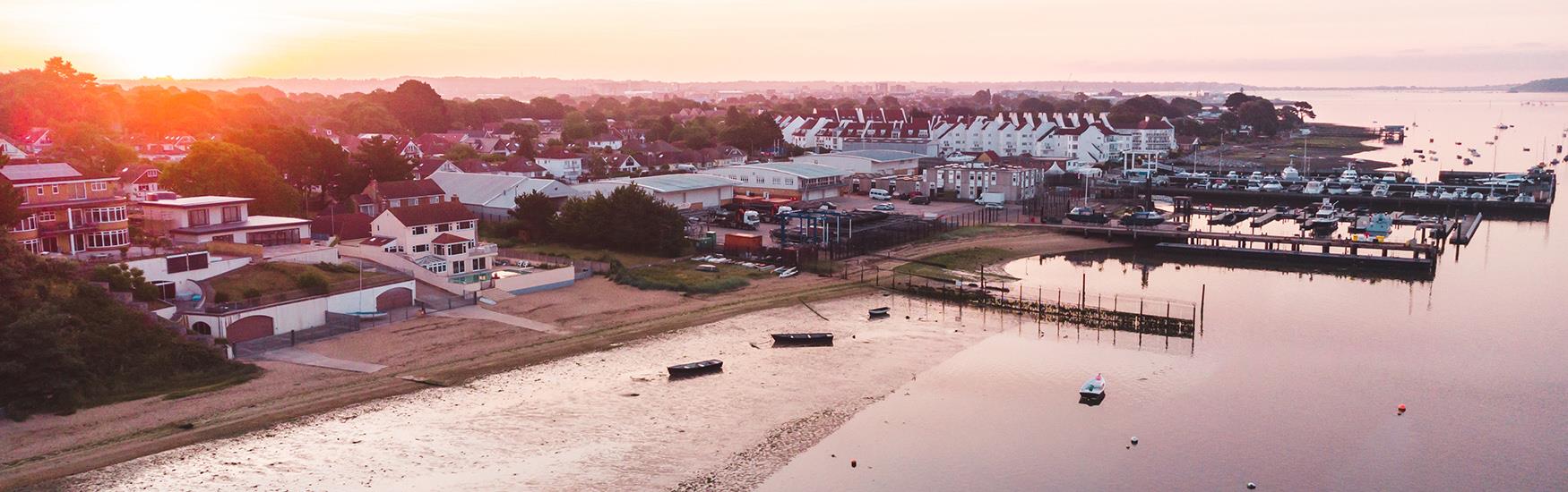 Sunset over Poole harbour and bay with hotels and accommodation by the sea