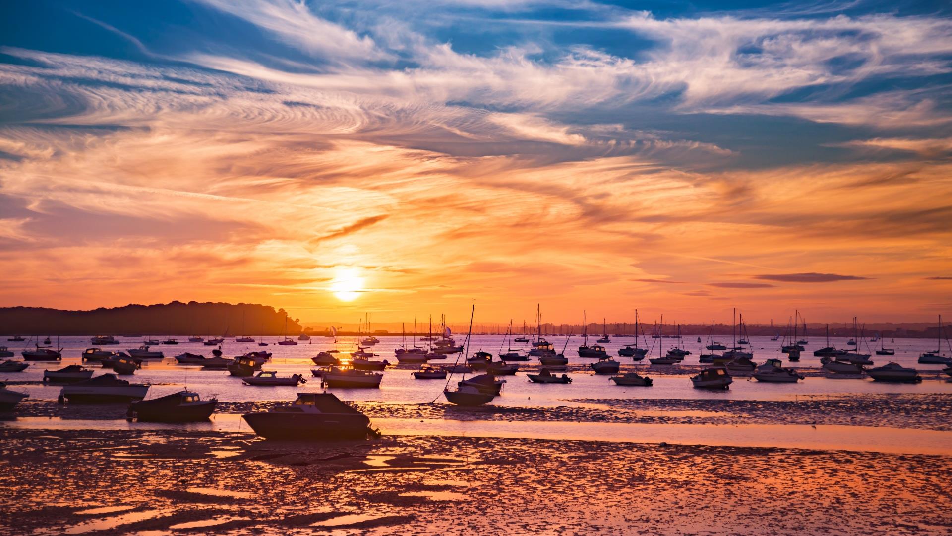 Fiery yet stunning sunset over poole harbour and moored boats