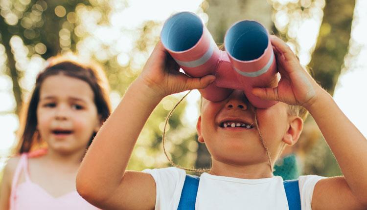 Child hold DIY cardboard binoculars