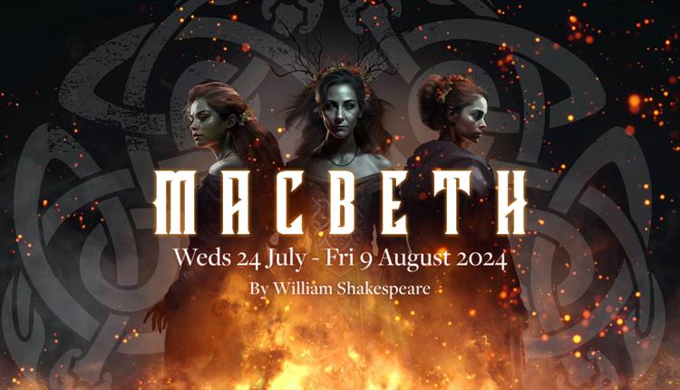 Three elegant witches dressed in black stand over a bonfire. Macbeth - Brownsea Open Air Theatre. 24 July to 9 August 2024