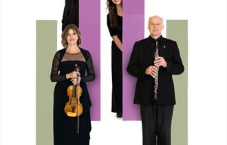 Four performers standing against a white pink and green background.  One performer is holding a violin and another an oboe.