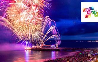 Beautiful colourful image of fireworks over Bournemouth Pier and the sea