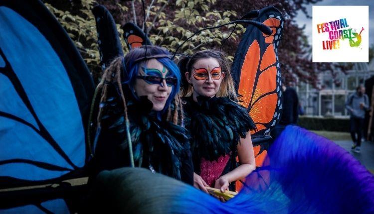 two ladies dressed up as giant butterflies