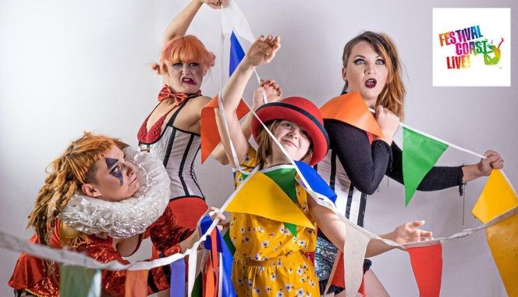 four people dresses as circus performers entangled in colourful bunting