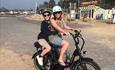 Woman and young boy e-biking together