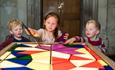 Children playing with interactive stained glass activity