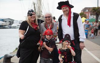 Family dressed up as pirates.
