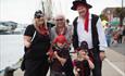 Family dressed up as pirates.