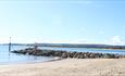 Shot of the beach groyne with clear skies over Poole Harbour