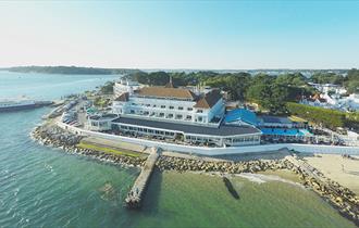 Drone shot over the sea of the Haven hotel and its jetty