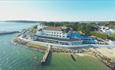 Drone shot over the sea of the Haven hotel and its jetty